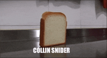 a slice of bread is sitting on a counter with the words collin snider above it