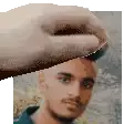 a hand is holding a man 's head in a pixel art .