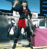 a girl is dancing on a stage in front of a sign that says gss