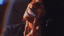 a blurry picture of a person 's face with a purple and pink background