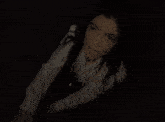 a close up of a person 's hand reaching for something in the dark