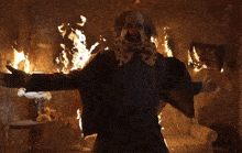 a man is sitting in a room with flames coming out of the walls