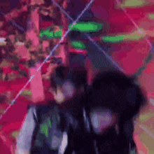 a blurry picture of a person wearing headphones in front of a red background .