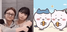 a couple of girls hugging next to a cartoon cat