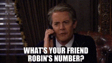 a man is talking on a cell phone and asking what 's your friend robin 's number ?