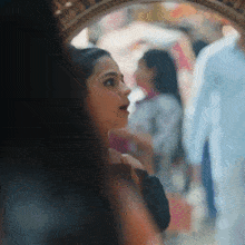 a woman is looking at herself in the mirror