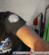 a person 's arm is shown with the words ishowspeed in the upper right corner