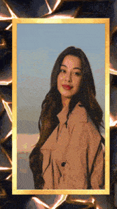 a picture of a woman in a trench coat with a gold frame