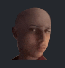 a close up of a bald man 's face with a serious look on his face