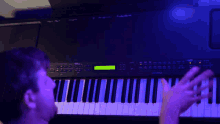 a man playing a keyboard with a green screen that says ' casio ' on it