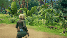 a woman is walking through a lush green forest in a video game