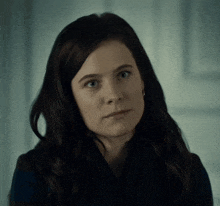 a close up of a woman 's face with dark hair