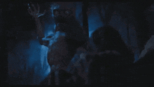 a silhouette of a monster is crawling through a dark cave .