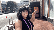 a woman stands in front of a sign that says laugh factory