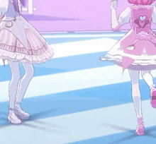 two anime girls in pink and white dresses are dancing