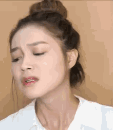 a close up of a woman making a funny face with her eyes closed .