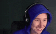 a woman wearing a blue hoodie and headphones