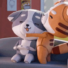 two stuffed animals are hugging each other and one has a remote control in its hand