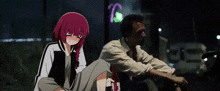 a man and a girl are sitting next to each other on the ground . the girl is holding a bottle of wine .