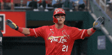 a baseball player wearing a red jersey that says the lou on it