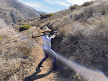 a woman wearing a hat is holding a pickaxe