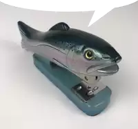 a stapler with a fish on it and a speech bubble above it .