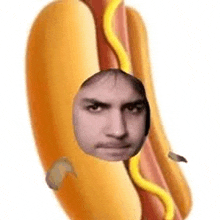 a man 's face is sticking out of a hot dog .