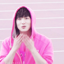 a person wearing a pink hoodie with the word shishimato on the bottom right