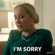 a woman sitting on a couch says i 'm sorry in a netflix ad