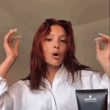 a woman in a white shirt holds a bottle of schwarzkopf 2