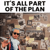 a man in a costume is standing in front of a bulletin board that says " it 's all part of the plan "