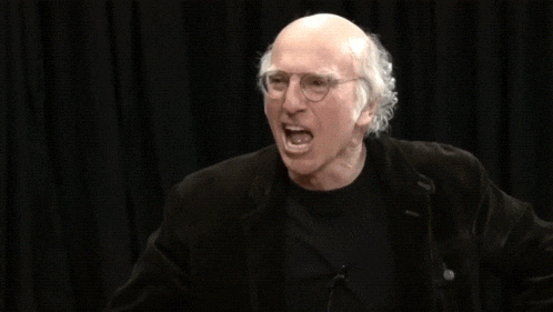 a bald man with glasses is screaming with the words 