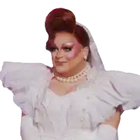 a drag queen is wearing a white wedding dress