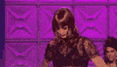 a woman in a leopard print top is dancing on a stage
