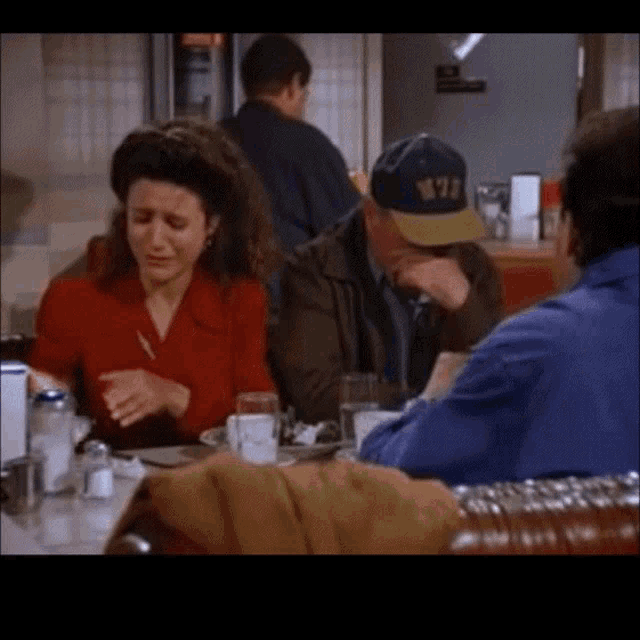 Seinfeld taking a napkin to wipe his mouth