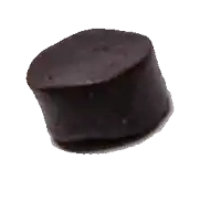 a small round piece of chocolate is on a white surface