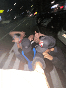 a blurry photo of a group of people with one wearing a hat that says ' supreme ' on it