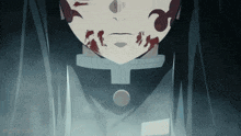 a close up of a person 's face with blood on it in a dark room .