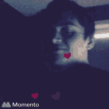 a purple background with hearts and the word momento