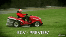 a man is riding a red lawn mower in a field .