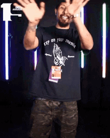 a man wearing a black t-shirt that says " keep on your enemie "