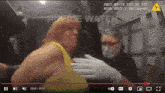 a woman in a yellow shirt is being helped by a police watch officer