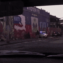 a police car is parked in front of a building that says ten fye