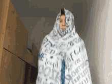 a person wrapped in a blanket that says ' i love you ' on it