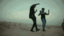 two men are dancing in the desert while holding a bag of chips .