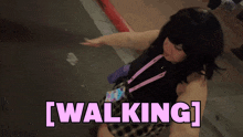 a woman with a lanyard around her neck is walking