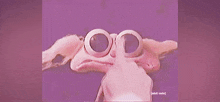 a close up of a cartoon character 's face with a purple background .