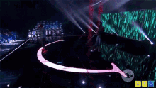 a man singing into a microphone on a stage with a sign that says ' sf ' on it