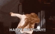 a woman is dancing on a stage with the words `` happy birthday ! ''