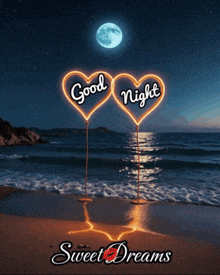 two neon hearts that say good night sweet dreams on the beach